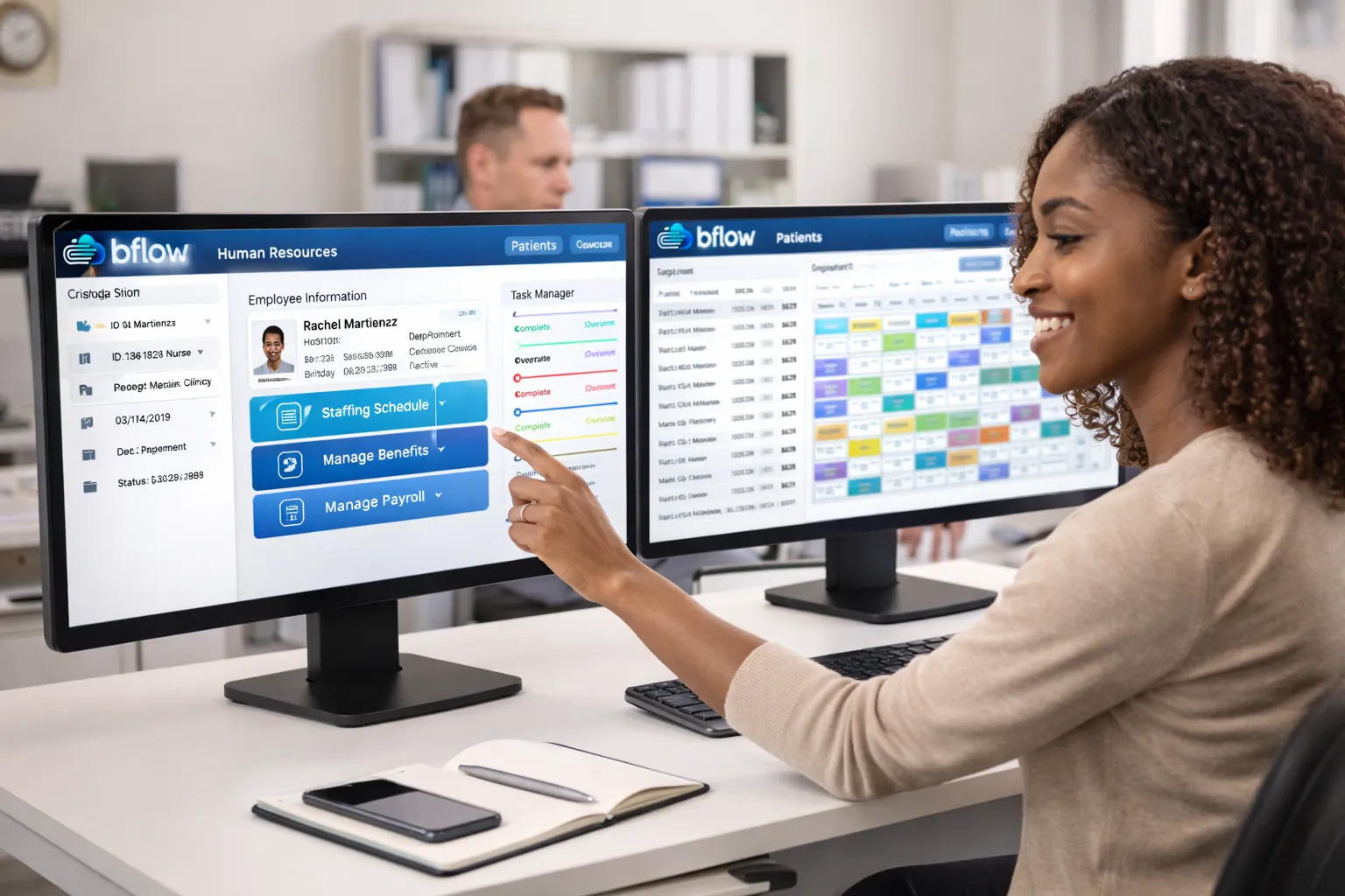 Office manager using BFLOW® workforce management and patient scheduling on dual monitors
